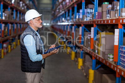 Serious manager working with a clipboard