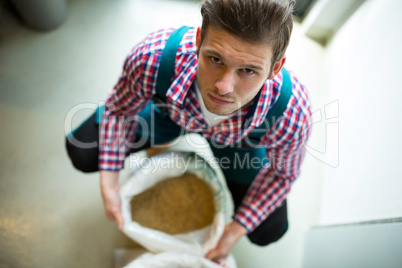 Brewer with sack of grains