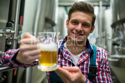 Brewer holding a glass of pint beer