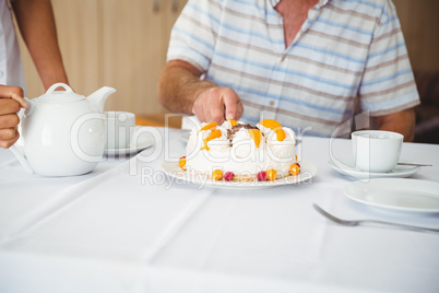 Patient is cutting the cake