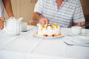 Patient is cutting the cake