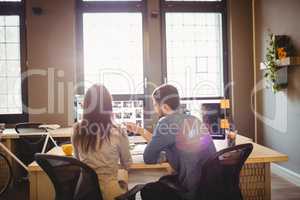 Graphic designers working at desk in the office