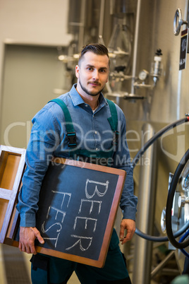 Portrait of bewer holding placard