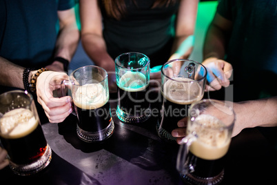 Group of friends holding beer mugs