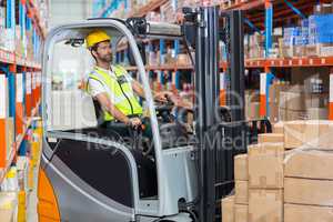 Worker is driving a pallet truck