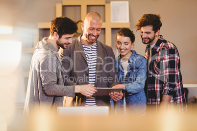 Graphic designer using digital tablet with his coworker Graphic designer using digital tablet with his coworker