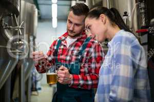 Brewers testing beer with litmus paper