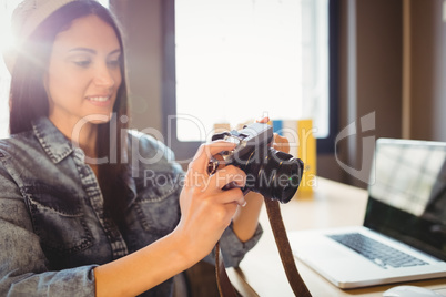 Graphic designer looking at pictures in digital camera