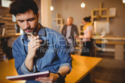 Graphic designer reading notes from his diary