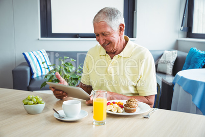 Senior man using a digital tablet