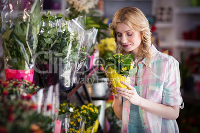 Happy female florist smelling a flower bouquet