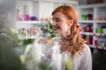 Female florist touching flower bouquet