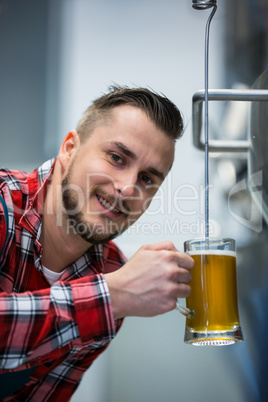 Close-up of brewer testing beer