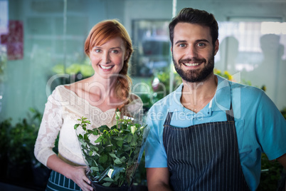 Happy couple holding flower bouquet