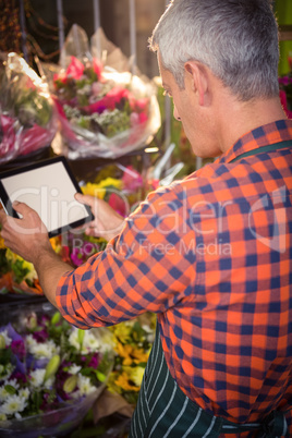 Male florist taking photo of flower bouquet