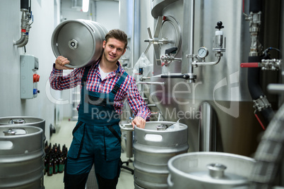 Brewer carrying keg on shoulder