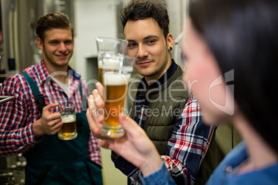 Brewers testing beer at brewery factory