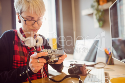 Graphic designer looking at pictures in digital camera