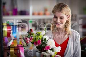 Female florist preparing a flower bouquet