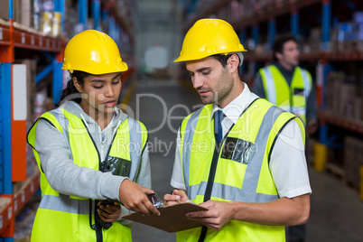 Workers looking at clipboard