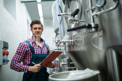 Maintenance worker holding on clipboard