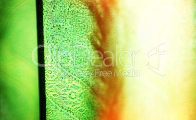 Horizontal vivid green curtain with light leak bokeh background