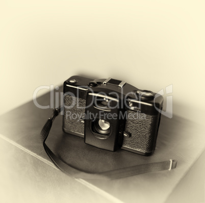 Vintage camera with strap bokeh background