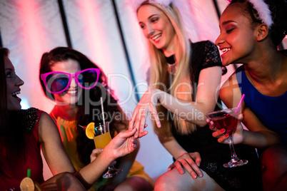 Woman showing engagement ring to her friends