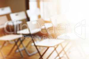 Classroom with empty chairs and warm bokeh background