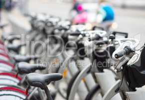 Diagonal bicycle row in street bokeh background
