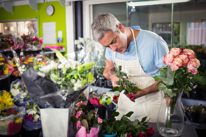 Male florist arranging flowers