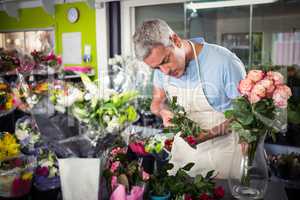 Male florist arranging flowers