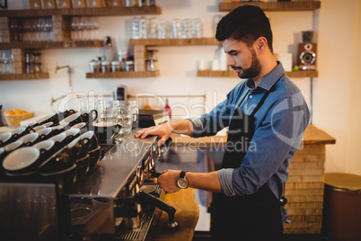 Man taking coffee from espresso machine