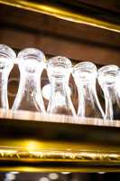 Glasses arranged on the bar shelf