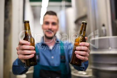 Brewer holding two beer bottle