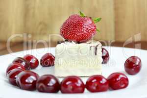 ripe red strawberries and cherries with cake