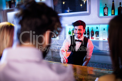 Waiter serving cocktail