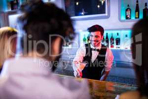 Waiter serving cocktail