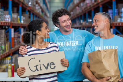 Happy volunteer are smiling and looking each other