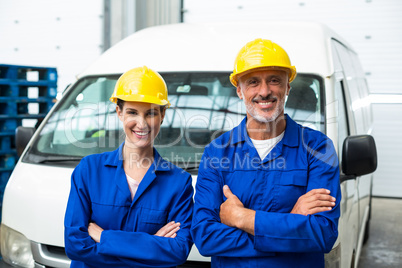 Smiling workers crossing arms at camera