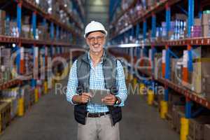 Portrait of happy worker is holding a tablet and posing