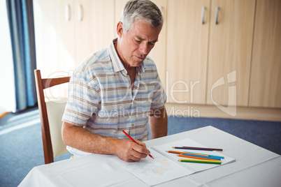 Senior man using a colouring book
