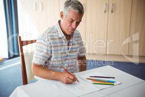 Senior man using a colouring book