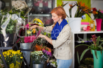 Female florist arranging flower bouquet