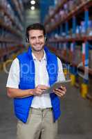 Smiling worker using digital tablet