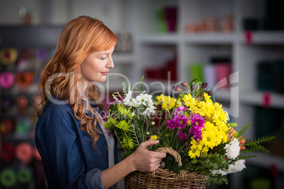 Female florist holding basket of flowers