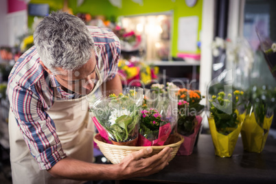 Male florist arranging bouquet of flower