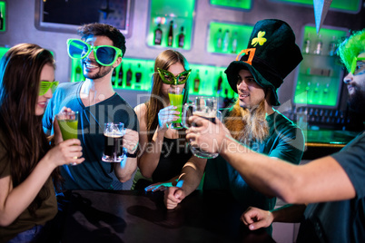Group of friends toasting beer mugs and drink glasses
