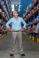 Men with hands on hips in warehouse