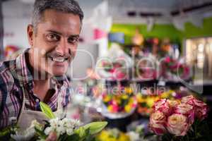 Smiling male florist at flower shop